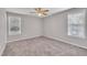 Spacious bedroom with carpet, ceiling fan, and natural light from two windows at 147 Tralee Dr, Smithfield, NC 27577