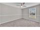Cozy bedroom featuring carpeted floors, a ceiling fan, and natural light at 147 Tralee Dr, Smithfield, NC 27577