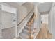 Bright hallway with a carpeted staircase and vinyl plank flooring at 147 Tralee Dr, Smithfield, NC 27577