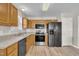 Well-appointed kitchen with wood cabinets, stainless steel appliances, and a light-colored countertop for a blend of style and functionality at 147 Tralee Dr, Smithfield, NC 27577