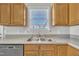 Bright kitchen features a stainless steel sink, durable countertops, and ample oak cabinetry at 147 Tralee Dr, Smithfield, NC 27577