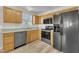 Inviting kitchen features wood cabinets, stainless steel appliances, and modern flooring for a blend of classic and contemporary charm at 147 Tralee Dr, Smithfield, NC 27577