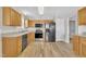 Charming kitchen with wood cabinets, stainless steel appliances, and a light-colored countertop; perfect for Gathering meals and entertaining at 147 Tralee Dr, Smithfield, NC 27577