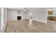Spacious living room with a fireplace and modern flooring, open to kitchen and dining area at 147 Tralee Dr, Smithfield, NC 27577