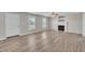 Large living area with light-colored floors, fireplace, and natural light from large windows at 147 Tralee Dr, Smithfield, NC 27577
