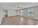 Bright living area featuring modern flooring, a ceiling fan, and ample natural light from the windows at 147 Tralee Dr, Smithfield, NC 27577