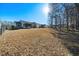 Spacious backyard with a screened in porch, wooded area, and fence at 153 Brindley Cir, Clayton, NC 27520
