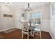 Bright dining area with a chandelier, hardwood floors, and wainscoting at 153 Brindley Cir, Clayton, NC 27520