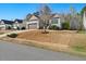 Exterior view of a single-story home with a well-manicured lawn and an attached two-car garage at 153 Brindley Cir, Clayton, NC 27520