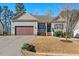 Charming one-story home with a well-maintained lawn, attached garage, and inviting front porch at 153 Brindley Cir, Clayton, NC 27520