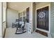 Inviting front porch with rocking chairs and a decorative door, creating a warm welcome at 153 Brindley Cir, Clayton, NC 27520