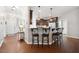 Open kitchen design with bar seating, dark cabinets, and stylish pendant lighting at 153 Brindley Cir, Clayton, NC 27520
