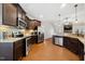 Modern kitchen with dark wood cabinets, stainless steel appliances, and granite countertops at 153 Brindley Cir, Clayton, NC 27520