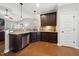 Well-appointed kitchen with dark cabinets, stainless steel dishwasher, and granite countertops at 153 Brindley Cir, Clayton, NC 27520