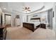 Main bedroom features a tray ceiling, ceiling fan, and a neutral color scheme at 153 Brindley Cir, Clayton, NC 27520