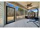Screened in porch with a chair swing, ceiling fan, and natural light at 153 Brindley Cir, Clayton, NC 27520