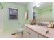 Bathroom featuring a vanity with a cream countertop and soft green walls, offering a refreshing space at 1603 Stonegate S, Sanford, NC 27332