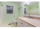 Bathroom featuring a vanity with a cream countertop and soft green walls, offering a refreshing space at 1603 Stonegate S, Sanford, NC 27332
