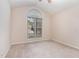 Bright bedroom featuring a large arched window allowing for natural light and neutral colored walls at 1603 Stonegate S, Sanford, NC 27332