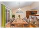 Dining area features wood table, six chairs and modern chandelier and leads into kitchen at 1603 Stonegate S, Sanford, NC 27332