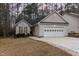 Inviting single-story home with lush landscaping, attached garage, and a cozy front entrance at 1603 Stonegate S, Sanford, NC 27332