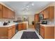 Well-lit kitchen featuring wooden cabinets, stainless steel appliances, and a seamless transition to the dining area at 1603 Stonegate S, Sanford, NC 27332
