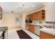 Functional kitchen features stainless steel appliances, tile floors, and ample cabinet space at 1603 Stonegate S, Sanford, NC 27332