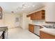 Well-lit kitchen features tiled floors, stainless steel appliances, and wooden cabinets at 1603 Stonegate S, Sanford, NC 27332