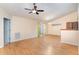 Bright living room with vaulted ceiling and wood floors leads to dining area and hallway at 1603 Stonegate S, Sanford, NC 27332