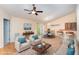 Bright living room with ceiling fan, seating and natural light from dining area sliding door at 1603 Stonegate S, Sanford, NC 27332