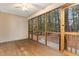 Inviting screened porch with a wood dining table set and views of the lush, wooded backyard at 1603 Stonegate S, Sanford, NC 27332