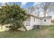 Backyard view showcasing the home's gray siding, white trim, and an air conditioning unit at 1614 Homewood Ave, Durham, NC 27707
