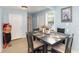 Dining room with light blue walls, light colored flooring, and a black table set for four at 1614 Homewood Ave, Durham, NC 27707