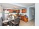 View of kitchen and dining area featuring light blue walls, light colored flooring, and wood cabinets at 1614 Homewood Ave, Durham, NC 27707