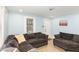 Comfortable living room featuring light blue walls, light colored floors, and a dark gray sectional sofa at 1614 Homewood Ave, Durham, NC 27707