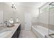 Bathroom featuring double sinks, granite countertops, soaking tub, and tiled floors at 1628 Highpoint St, Wake Forest, NC 27587
