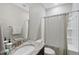 Bright bathroom featuring granite countertop, patterned shower curtain, and ample lighting at 1628 Highpoint St, Wake Forest, NC 27587