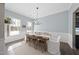 Light-filled dining room with wainscoting, wood table, and lots of natural light at 1628 Highpoint St, Wake Forest, NC 27587