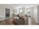 Bright living room featuring hardwood floors and comfortable seating area with decorative rug at 1628 Highpoint St, Wake Forest, NC 27587