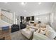 Open-concept living room flows into the kitchen, featuring large sofas and lots of seating at 1628 Highpoint St, Wake Forest, NC 27587