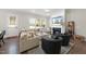 Comfortable living room with a fireplace, large windows, and stylish furniture at 1628 Highpoint St, Wake Forest, NC 27587