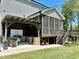 Backyard featuring an outdoor kitchen, screened-in porch, and a spacious yard at 197 S Clearbook Ct, Angier, NC 27501