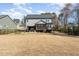 Backyard view showcasing the patio, outdoor kitchen, deck, and spacious lawn at 197 S Clearbook Ct, Angier, NC 27501