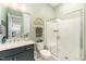 Modern bathroom featuring a glass shower, quartz counters, and blue vanity at 197 S Clearbook Ct, Angier, NC 27501