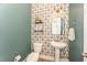 Charming half bathroom with pedestal sink, decorative wallpaper, and modern fixtures at 197 S Clearbook Ct, Angier, NC 27501