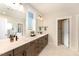 Bright bathroom with double vanity, sleek fixtures, and a view of the glass shower at 197 S Clearbook Ct, Angier, NC 27501
