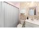 Compact bathroom with a shower, single vanity, and playful, abstract wallpaper at 197 S Clearbook Ct, Angier, NC 27501