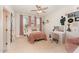 Bright bedroom featuring pink accents, a vanity, and ample natural light at 197 S Clearbook Ct, Angier, NC 27501