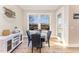 Cozy dining area bathed in natural light, complemented by stylish furnishings and backyard views at 197 S Clearbook Ct, Angier, NC 27501