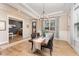 Elegant dining room with dark wood table, chandelier, wainscoting, and view to a cozy living room at 197 S Clearbook Ct, Angier, NC 27501